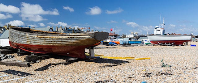 Colourful, old wooden boats rest on the beach